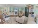 Spacious living room featuring a fireplace, plush seating, and seamless access to additional living spaces at 4312 14Th E St, Ellenton, FL 34222