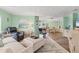 Inviting living room featuring wood floors, comfortable seating, and an open layout leading into the dining area at 4312 14Th E St, Ellenton, FL 34222