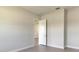 Minimalist bedroom with neutral colors, tile flooring, and a doorway to another room at 4324 Sea Marsh Pl, Parrish, FL 34219