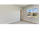 Well-lit bedroom with neutral walls, tile flooring, and a large window overlooking the neighborhood at 4324 Sea Marsh Pl, Parrish, FL 34219