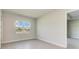 Bright bedroom featuring tile floors, neutral walls, and a window overlooking the neighborhood at 4324 Sea Marsh Pl, Parrish, FL 34219