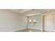 Neutral living room with large window, light tile floors, and white trim at 4324 Sea Marsh Pl, Parrish, FL 34219