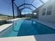 Sparkling swimming pool under a screened enclosure, perfect for outdoor relaxation at 4324 Sea Marsh Pl, Parrish, FL 34219