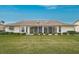 Well-maintained home exterior features manicured lawn, trimmed bushes, and sliding glass doors to the sun room at 4360 Presidential Avenue E Cir, Bradenton, FL 34203