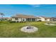 Back of the home shows sliding glass doors, and lush green lawn and landscaping at 4360 Presidential Avenue E Cir, Bradenton, FL 34203