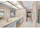 Bathroom with dual sinks, a large mirror, and access to a shower and soaking tub at 4360 Presidential Avenue E Cir, Bradenton, FL 34203