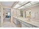 Bathroom featuring double sinks, a large mirror, and easy access to the shower and toilet at 4360 Presidential Avenue E Cir, Bradenton, FL 34203
