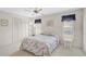 Bright bedroom featuring a bed, a ceiling fan, a closet, and dual windows at 4360 Presidential Avenue E Cir, Bradenton, FL 34203