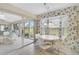 Bright dining area features a sliding glass door to a lanai, a ceiling fan, and bamboo-print wallpaper at 4360 Presidential Avenue E Cir, Bradenton, FL 34203