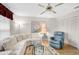 Cozy living room features a plush sectional sofa, recliner, ceiling fan, and decorative rug over hardwood floors at 4360 Presidential Avenue E Cir, Bradenton, FL 34203