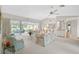 Spacious living area with plenty of seating, glass sliding doors, and a stylish bar area at 4360 Presidential Avenue E Cir, Bradenton, FL 34203