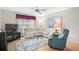 Bright living room featuring a plush sectional sofa, recliner, ceiling fan, and decorative rug over hardwood floors at 4360 Presidential Avenue E Cir, Bradenton, FL 34203