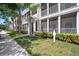 Exterior of condos showing walkway with well manicured shrubs lining the sidewalk on a bright sunny day at 4802 51St W St # 1908, Bradenton, FL 34210