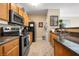 Well-lit kitchen with stainless steel appliances, warm wood cabinetry, and stylish countertops at 4802 51St W St # 1908, Bradenton, FL 34210