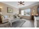 Bright living room with hardwood floors, plush furniture, and a large window at 4802 51St W St # 1908, Bradenton, FL 34210