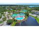 This aerial showcases the community pool, lake, clubhouse and surrounding lush greenery at 4802 51St W St # 704, Bradenton, FL 34210