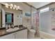 Bright bathroom features a shower-tub combo, neutral tiling, and beach-themed decor at 4802 51St W St # 704, Bradenton, FL 34210