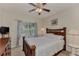 A view of a bedroom with a ceiling fan and a decorative comforter at 4802 51St W St # 704, Bradenton, FL 34210
