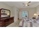 A view of a bedroom with a ceiling fan and a decorative comforter at 4802 51St W St # 704, Bradenton, FL 34210