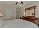 A view of a bedroom with a ceiling fan and a decorative comforter at 4802 51St W St # 704, Bradenton, FL 34210