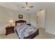 A view of a bedroom with a ceiling fan and a decorative comforter at 4802 51St W St # 704, Bradenton, FL 34210