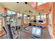 Community gym featuring weight machines, treadmills, and multiple windows overlooking the pond at 4802 51St W St # 704, Bradenton, FL 34210
