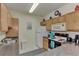 A view of the kitchen featuring light cabinets, white appliances, and a grey countertop at 4802 51St W St # 704, Bradenton, FL 34210