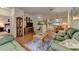 Spacious living area featuring hardwood floors and comfortable seating adjacent to dining and kitchen at 4802 51St W St # 704, Bradenton, FL 34210
