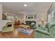 Bright and inviting living room with comfortable green sofas and dining area adjacent at 4802 51St W St # 704, Bradenton, FL 34210