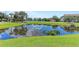 A tranquil pond reflects the sky, enhancing the community's natural beauty at 4802 51St W St # 704, Bradenton, FL 34210