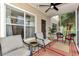 Relaxing screened porch with neutral furniture, ceiling fan, rug, and views of tropical landscaping at 4802 51St W St # 704, Bradenton, FL 34210