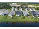Backyard view of homes next to a pristine lake in a well-maintained neighborhood at 4839 Deep Creek Ter, Parrish, FL 34219