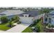 Aerial view of a home with a dark roof, landscaped front yard, and paved driveway at 4839 Deep Creek Ter, Parrish, FL 34219