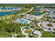 Aerial view of a neighborhood with community pool, playground, and lush landscaping at 4839 Deep Creek Ter, Parrish, FL 34219