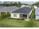 A view of the backyard with manicured lawn, fence, tasteful landscaping, and screened-in patio at 4839 Deep Creek Ter, Parrish, FL 34219