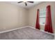 Cozy carpeted bedroom with a ceiling fan, window, and soft natural light at 4839 Deep Creek Ter, Parrish, FL 34219
