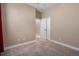 Empty carpeted bedroom with neutral walls and trim; doorway leading to the hall at 4839 Deep Creek Ter, Parrish, FL 34219