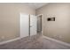 Carpeted bedroom with a closet, open door to the hallway and tv mount at 4839 Deep Creek Ter, Parrish, FL 34219