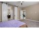 Serene bedroom showcases sliding barn doors, plush carpet, and access to an ensuite bathroom at 4839 Deep Creek Ter, Parrish, FL 34219