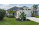 Exterior shot of the home with lovely landscaping and green grass under a cloudy sky at 4839 Deep Creek Ter, Parrish, FL 34219