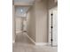 Inviting hallway with neutral paint, tiled floors, and white trim, leading to various rooms at 4839 Deep Creek Ter, Parrish, FL 34219