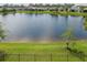 A scenic view of a large lake beyond a well-maintained backyard at 4839 Deep Creek Ter, Parrish, FL 34219