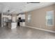 Open-concept living area flows into a modern kitchen, featuring neutral tones and ample natural light at 4839 Deep Creek Ter, Parrish, FL 34219