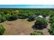 Breathtaking aerial view of expansive land with lush trees and the barn nestled among the landscape at 4876 253Rd E St, Myakka City, FL 34251