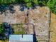 Aerial view showing barn with fenced in pens, and metal roof at 4876 253Rd E St, Myakka City, FL 34251
