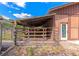 Outside view of the barn with a wooden awning and metal holding pen at 4876 253Rd E St, Myakka City, FL 34251