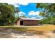 Exterior view of metal barn with drive in access and attached stables at 4876 253Rd E St, Myakka City, FL 34251