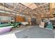 View of the large metal barn, with items stored and high ceilings at 4876 253Rd E St, Myakka City, FL 34251