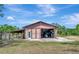Spacious metal barn interior showing large garage door with equipment and stalls on the side at 4876 253Rd E St, Myakka City, FL 34251