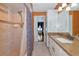 Tiled bathroom with step-in shower, granite counters, and a view into a bedroom at 4876 253Rd E St, Myakka City, FL 34251